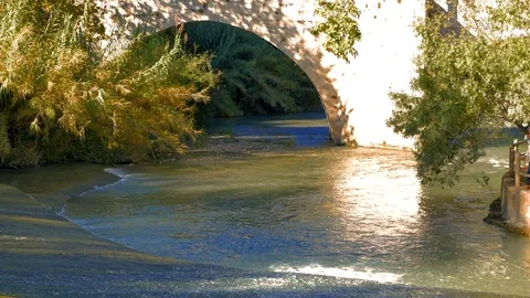 Reflection of church in progress of river under a stone bridge Stock Footage 124390935