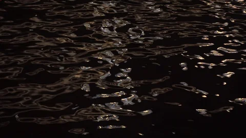 The reflection of city lights in the water of the river in the night Stock Footage 122389010