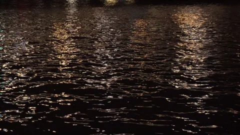 The reflection of city lights in the water of the river in the night Stock Footage 122389290