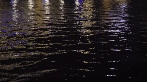 The reflection of city lights in the water of the river in the night Stock Footage 122391339