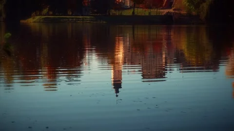 Reflection of cityscape with tower in rippled lake during autumn Stock Footage 292788443