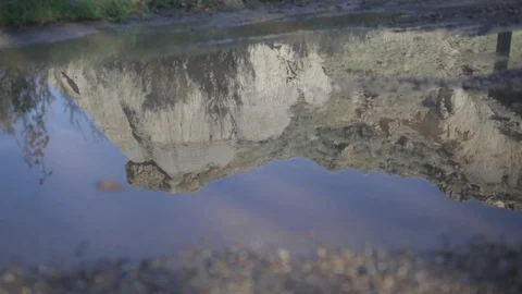 Reflection of a cliff face in a puddle in Alberta Stock Footage 90840223