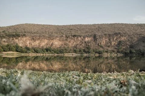Reflection of a cliff in a lake Stock Photos