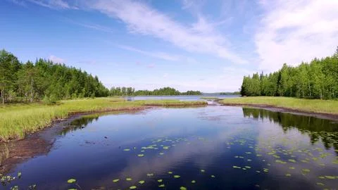 Reflection of clouds and blue sky in the mountain forest lake Värsjön Fotos Stock
