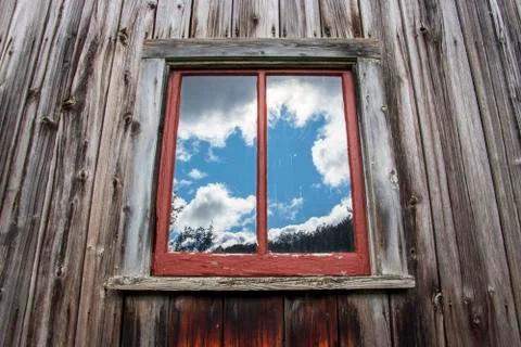 Reflection of clouds on a barn window Stock Photos