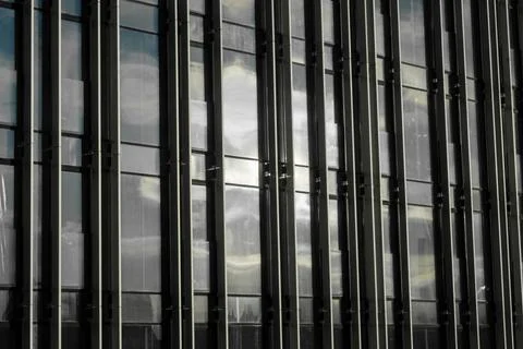 Reflection of Clouds on Building Glass at Midday Under Clear Sky in Urban Area 写真素材
