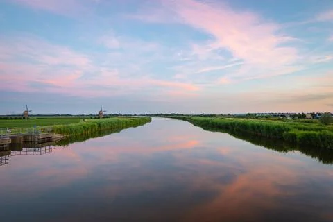 Reflection of clouds in the calm water of a river Stock Photos