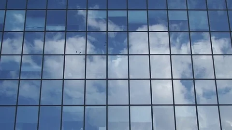 Reflection of clouds in the glass surface of a high-rise building Stock Footage 84827948