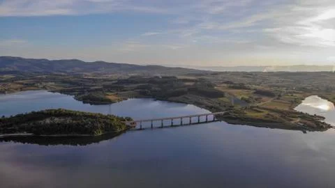 Reflection of clouds in the lake. Beginning of sunset. Stock Photos
