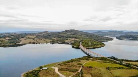 Reflection of clouds in the lake. Beginning of sunset. Stock Photos
