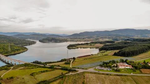 Reflection of clouds in the lake. Beginning of sunset. Stock Photos