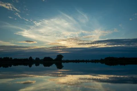 Reflection of clouds in the lake water Stock Photos