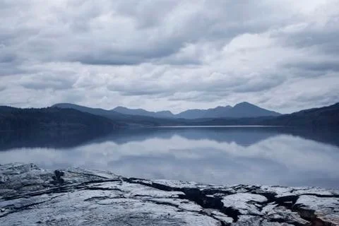 Reflection of clouds in mountain lake Stock Illustration