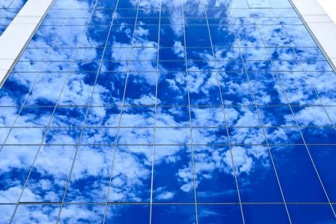 Reflection of clouds on office building Stock Photos