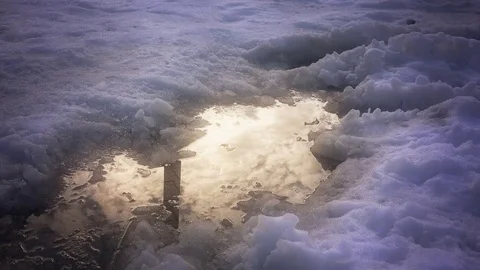 Reflection of clouds in the water among the melting snow Video stock 72119734