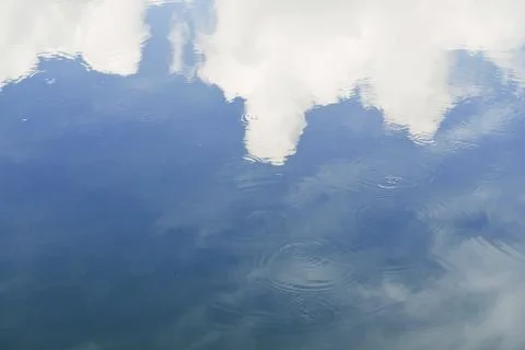 A reflection clouds on the water in the evening. Stock Photos