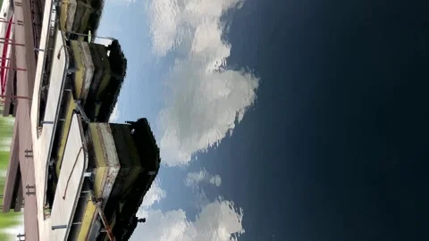 Reflection of clouds in the water near the pier, mooring for yachts and boats Stock Footage 244923898