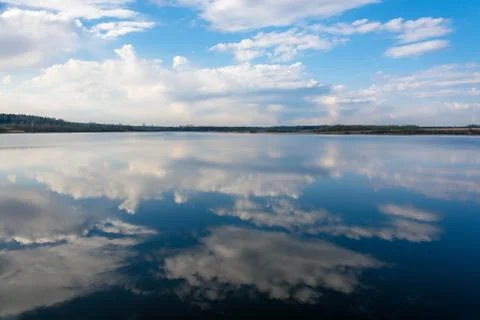 Reflection of clouds in water. Stock Photos