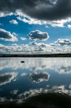 Reflection of clouds on the water Stock Photos