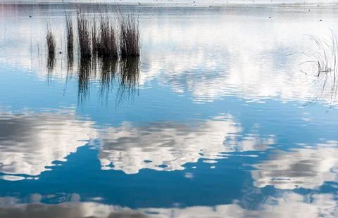 Reflection of clouds on the water Stock Photos