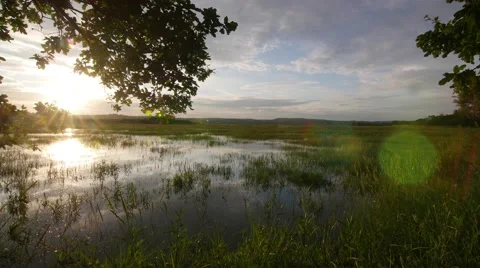 Reflection of clouds in water at sunset Stock Footage 66776865