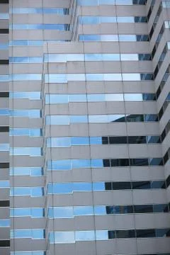 Reflection of clouds in the windows of high-rise building financial and busin Stock Photos