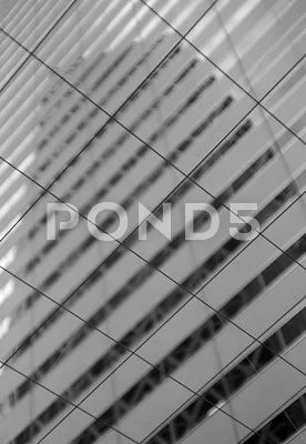 Reflection of the Cocoon Tower through the grid
