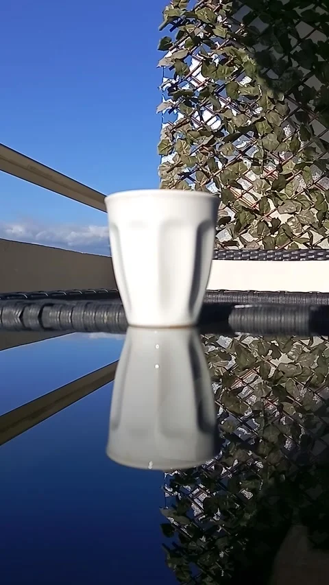 Reflection of a coffee cup on the glass table Stock Footage 325966705
