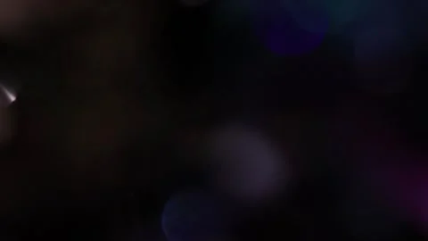 The reflection of colored bokeh lights softly glows in the darkness. Stock-Footage 317447593