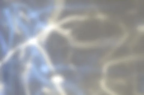 Reflection of colored rays on a gray background Stock Photos