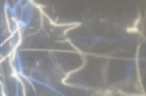 Reflection of colored rays on a gray background Stock Photos