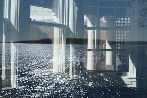A reflection of complex ocean wave patterns in an old window Stock Photos