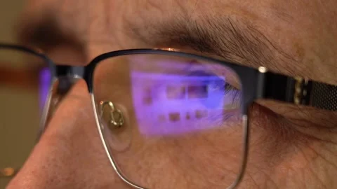 Reflection of the Computer Screen in Glasses. Elderly Man's Eyes with Glasses Stock Footage 145747988