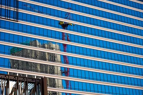 Reflection of construction crane Stock Photos