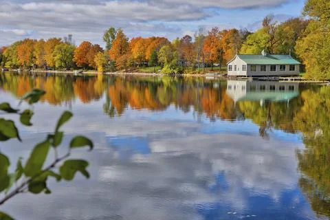 Reflection of the cottages and fall leaf color in the lake Stock Photos