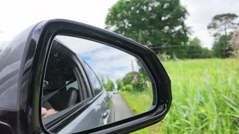 Reflection of Countryside Road in Car Side Mirror During Summer Road Trip Stock Footage 335361588
