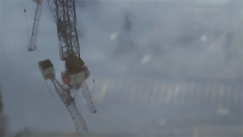 Reflection of crane in puddle as someone walks through Stock Footage 93202249