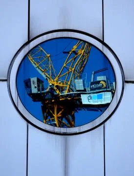 Reflection Of A Crane In Round Window Stock Photos