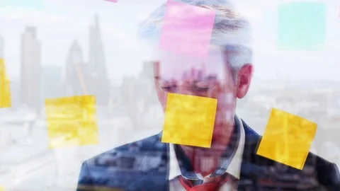 Reflection of a creative businessman putting post it notes on to a window Video stock 80172356