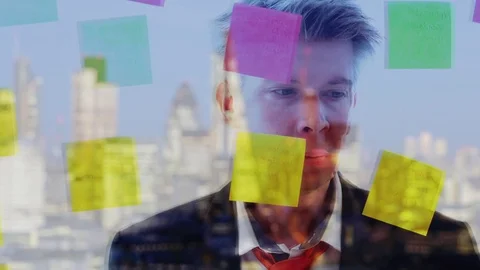 Reflection of a creative businessman putting post it notes on to a window Video stock 80174130