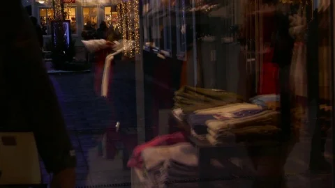 Reflection of crowd of people shopping cloths on the window of a shop store Stock Footage 70150489