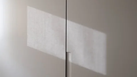 Reflection of curtain cord on the wall. Shadow in movement concept Stock Footage 126390627