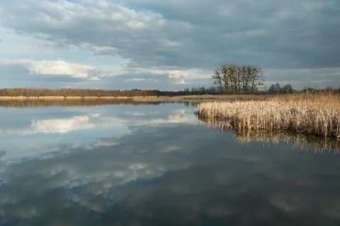 The reflection of dark clouds in a peaceful lake Stock Photos
