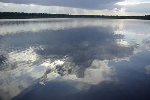 Reflection of dark clouds in the water. Stock Photos