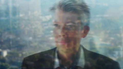 Reflection of a daydreaming businessman looking out of a window Stock Footage 80689502
