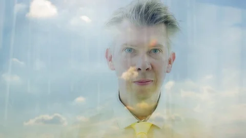 Reflection of a daydreaming businessman looking out of a window Video stock 80737802