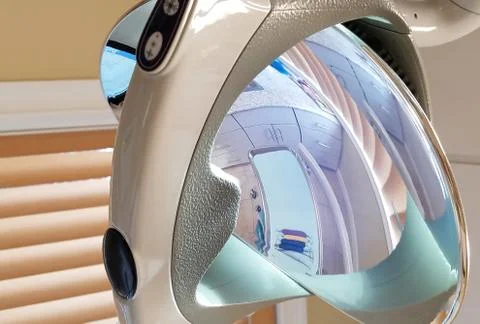 Reflection of a dentist special instruments on the operatory lighting and mir Stock Photos