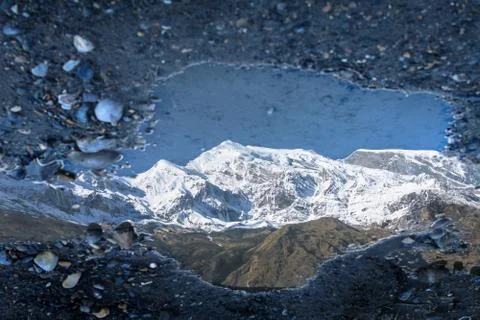 Reflection of Dhaulagiri mountain range in a puddle Stock Photos