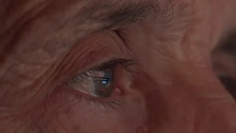 Reflection of digital screen in old mans eye Stock Footage 304845436