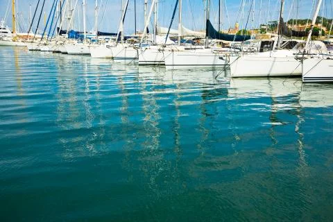 Reflection of docking yachts on the surface of calm water 스톡 사진